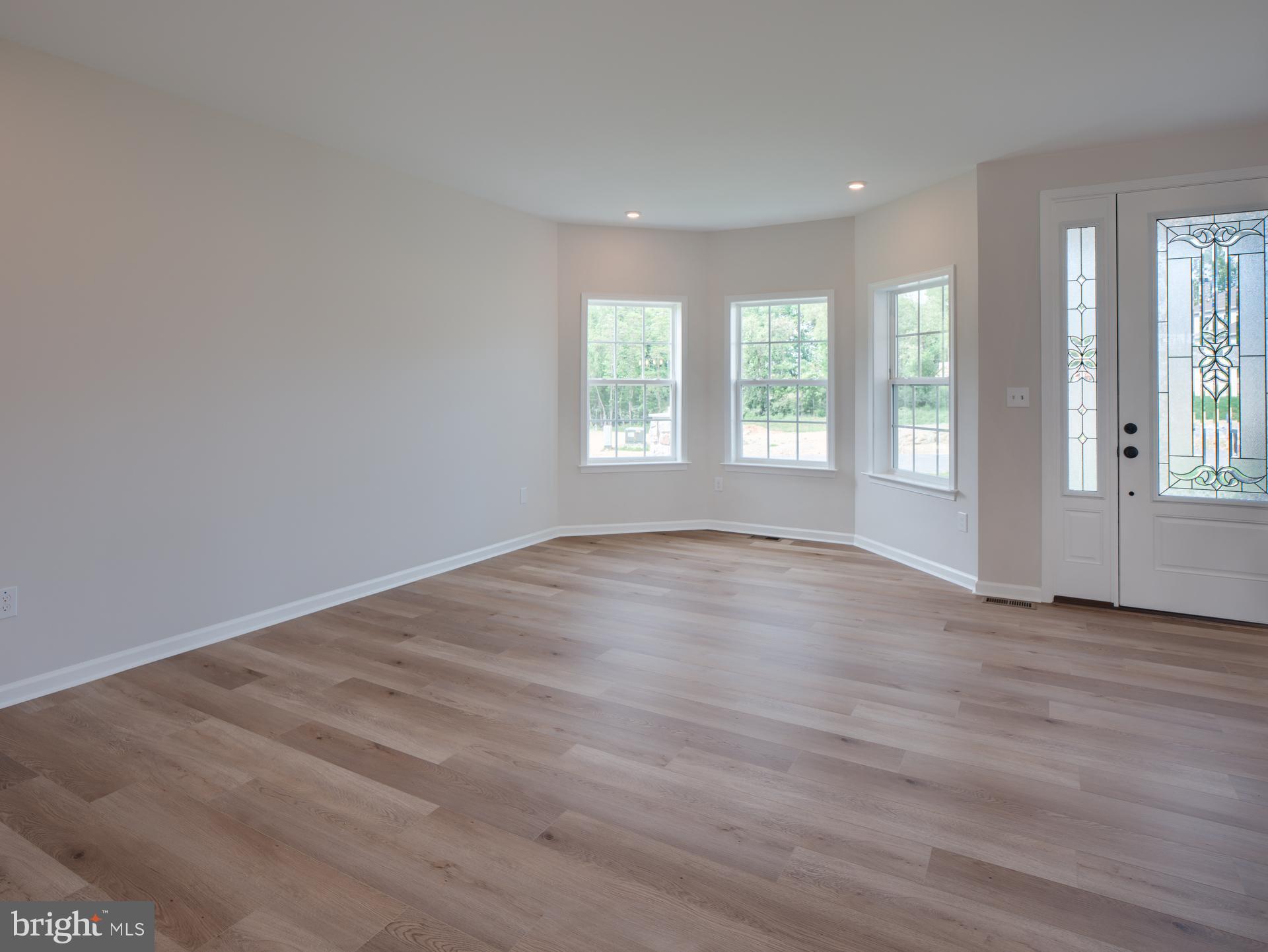 232 West Side Drive Lititz, PA 17543 - Photo 10 of 27 an empty room with wooden floor and windows