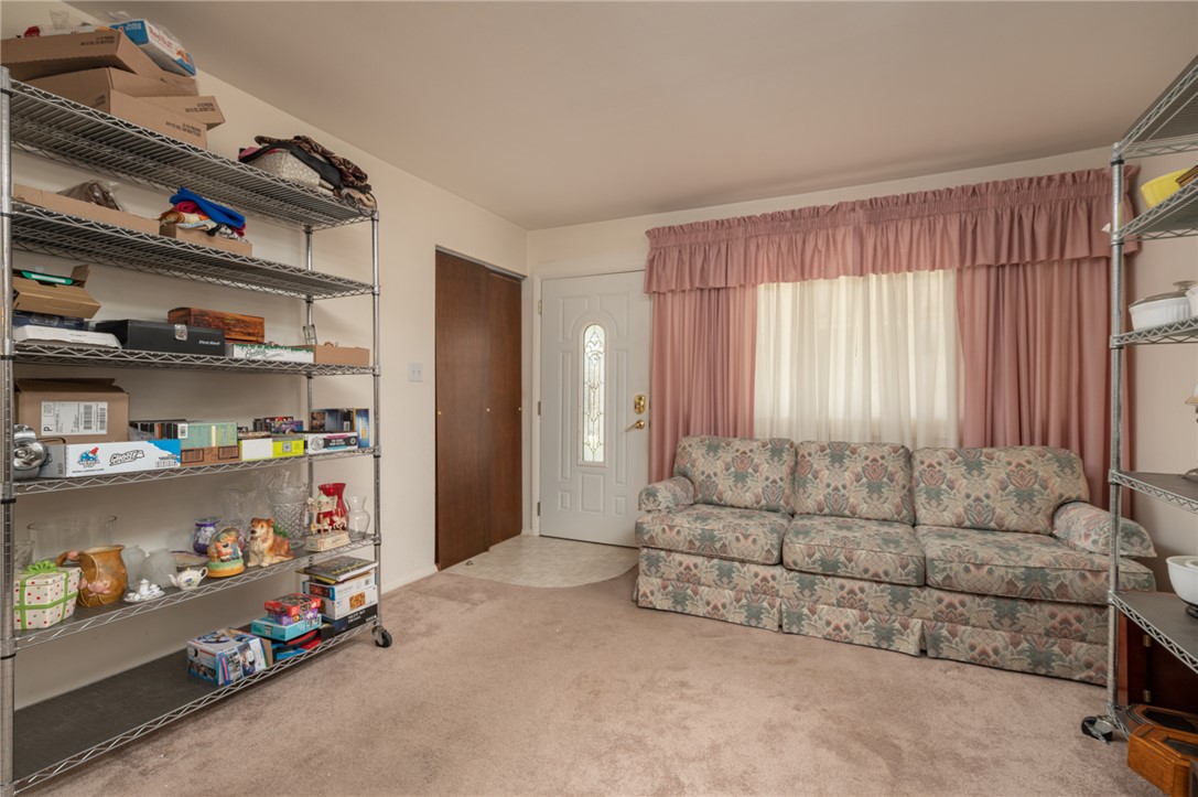 795 Spring Garden Place Dayton, OH 45431 - Photo 18 of 34 This inviting living area features plush carpeting, a large window, and a door for convenient access.