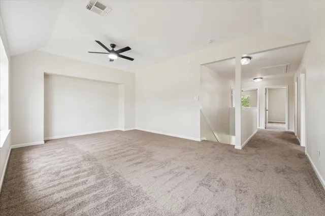 a view of empty room with ceiling fan