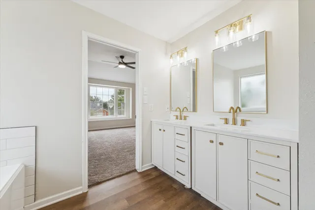a bathroom with a double vanity sink and mirror with shower
