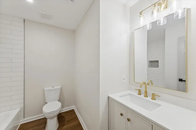 a bathroom with a sink toilet and a mirror