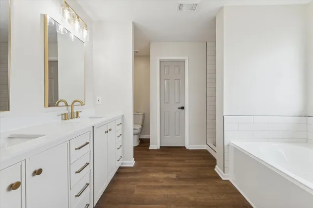 a bathroom with a sink a mirror and a bathtub
