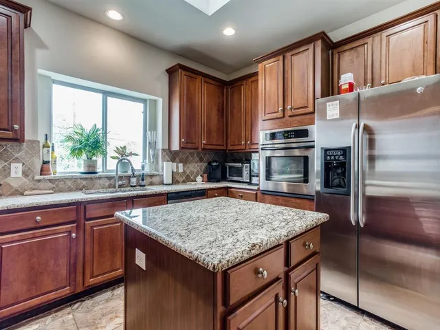 a kitchen with a stove a sink and a refrigerator