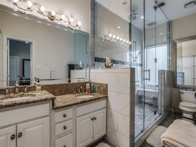 a bathroom with a sink double vanity and a shower