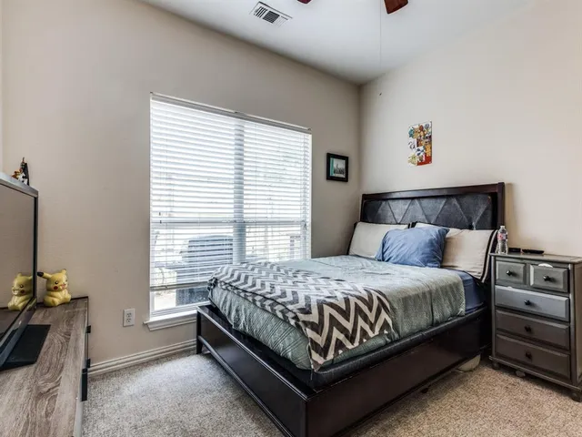 a bed sitting in a bedroom next to a window