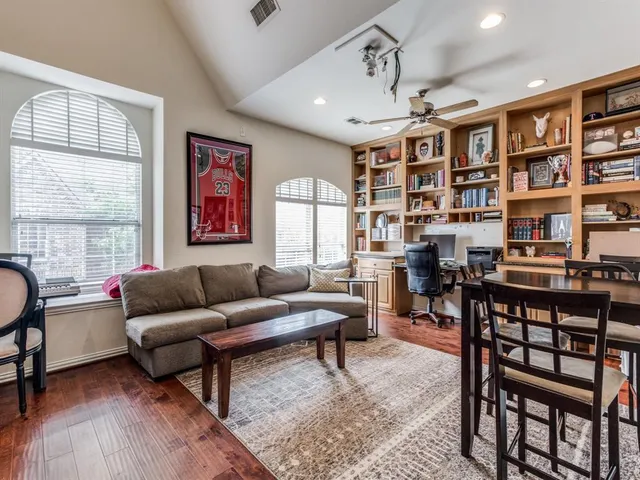 a living room with furniture a rug and a large window