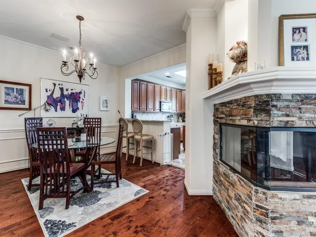 a dining room with furniture a chandelier and wooden floor