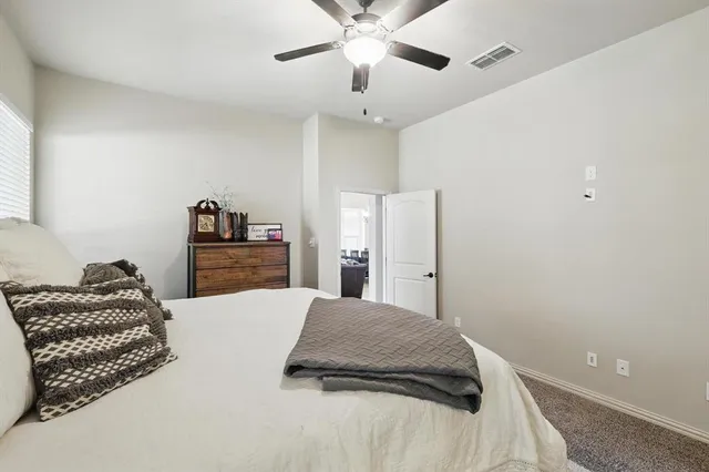 a bedroom with a bed and ceiling fan
