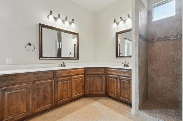 a spacious bathroom with a double vanity sink mirror and