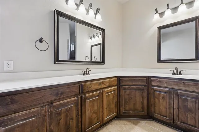 a bathroom with a double vanity sink and a mirror