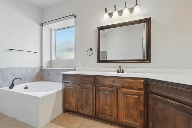 a bathroom with a sink vanity and mirror