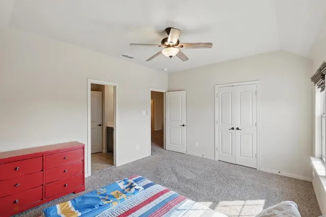 a bedroom with a bed and a dresser in it
