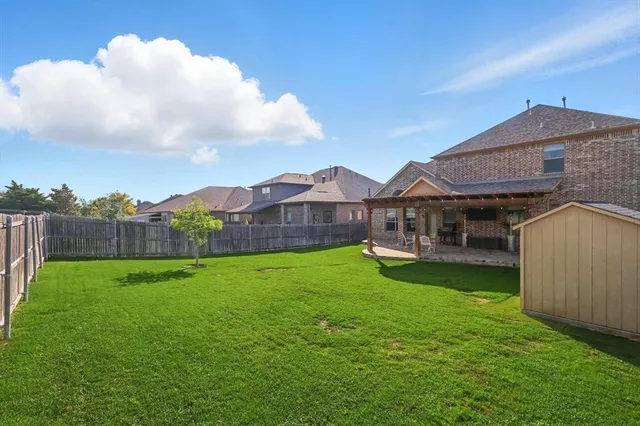 a backyard of a house with table and chairs
