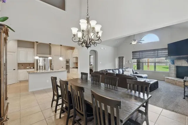 a view of a dining room with furniture a chandelier and wooden floor