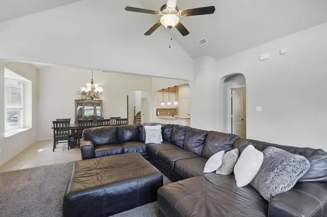 a living room with furniture and a chandelier