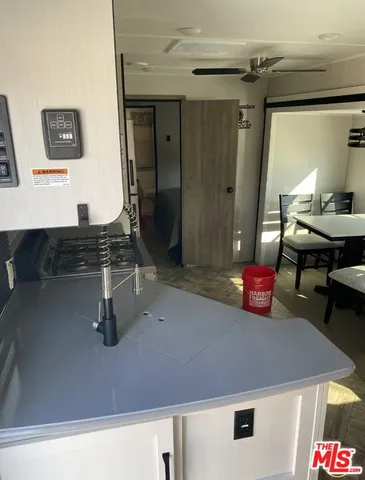 a kitchen with a sink a stove and a wooden floor