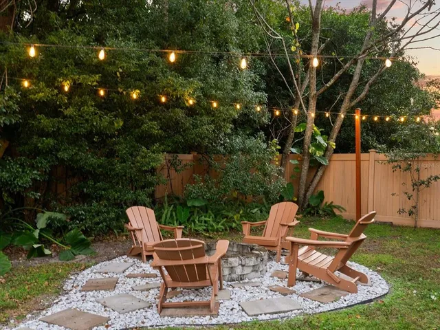 a view of a house with backyard sitting area and garden