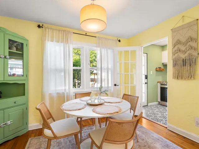 a view of a dining room with furniture and wooden floor
