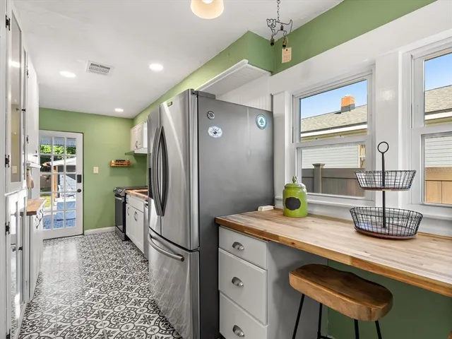 a kitchen with a sink stove and cabinets