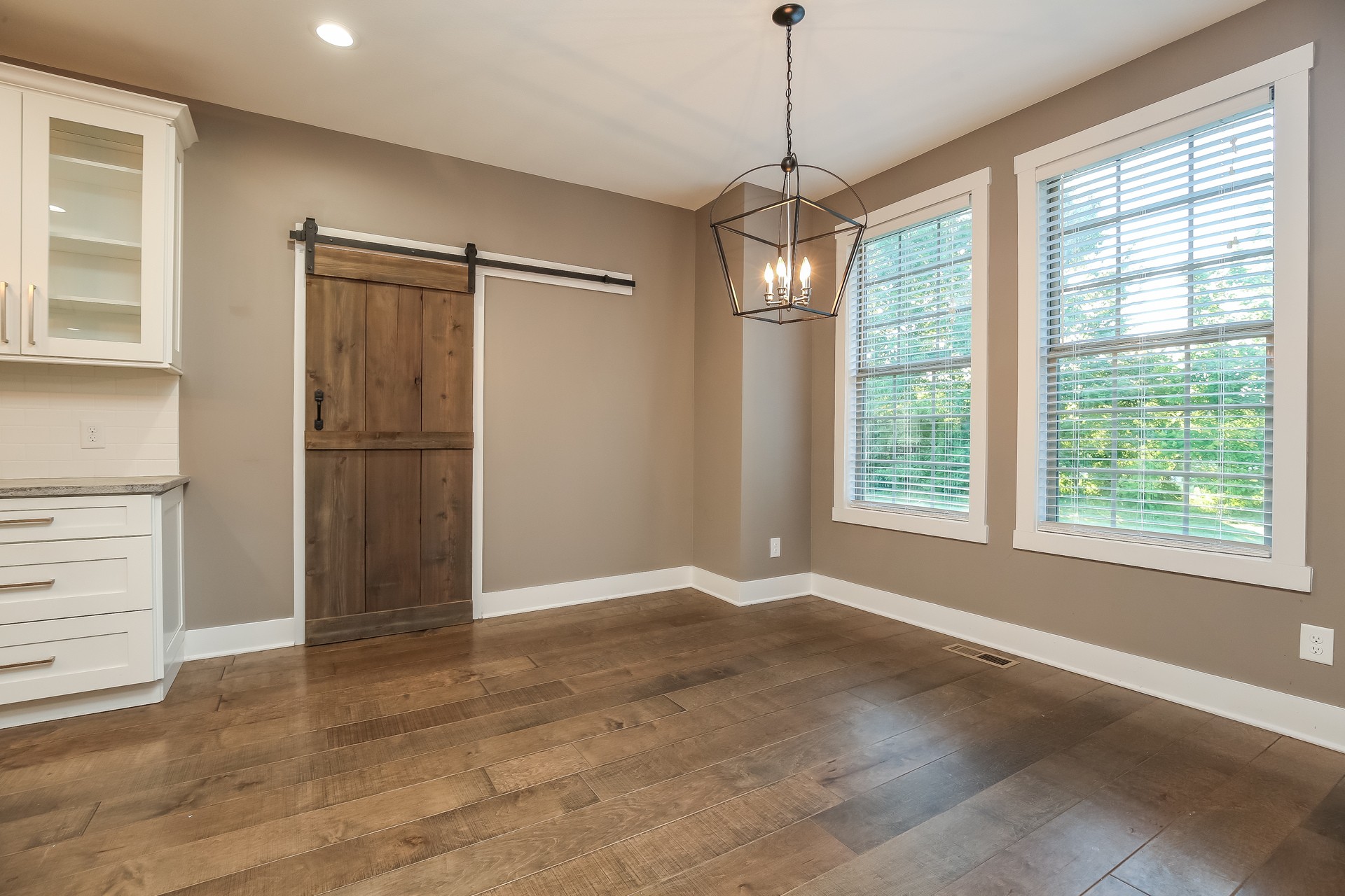 259 Harrowgate Drive Clarksville, TN 37043 - Photo 12 of 27 a view of an empty room with a window and wooden floor