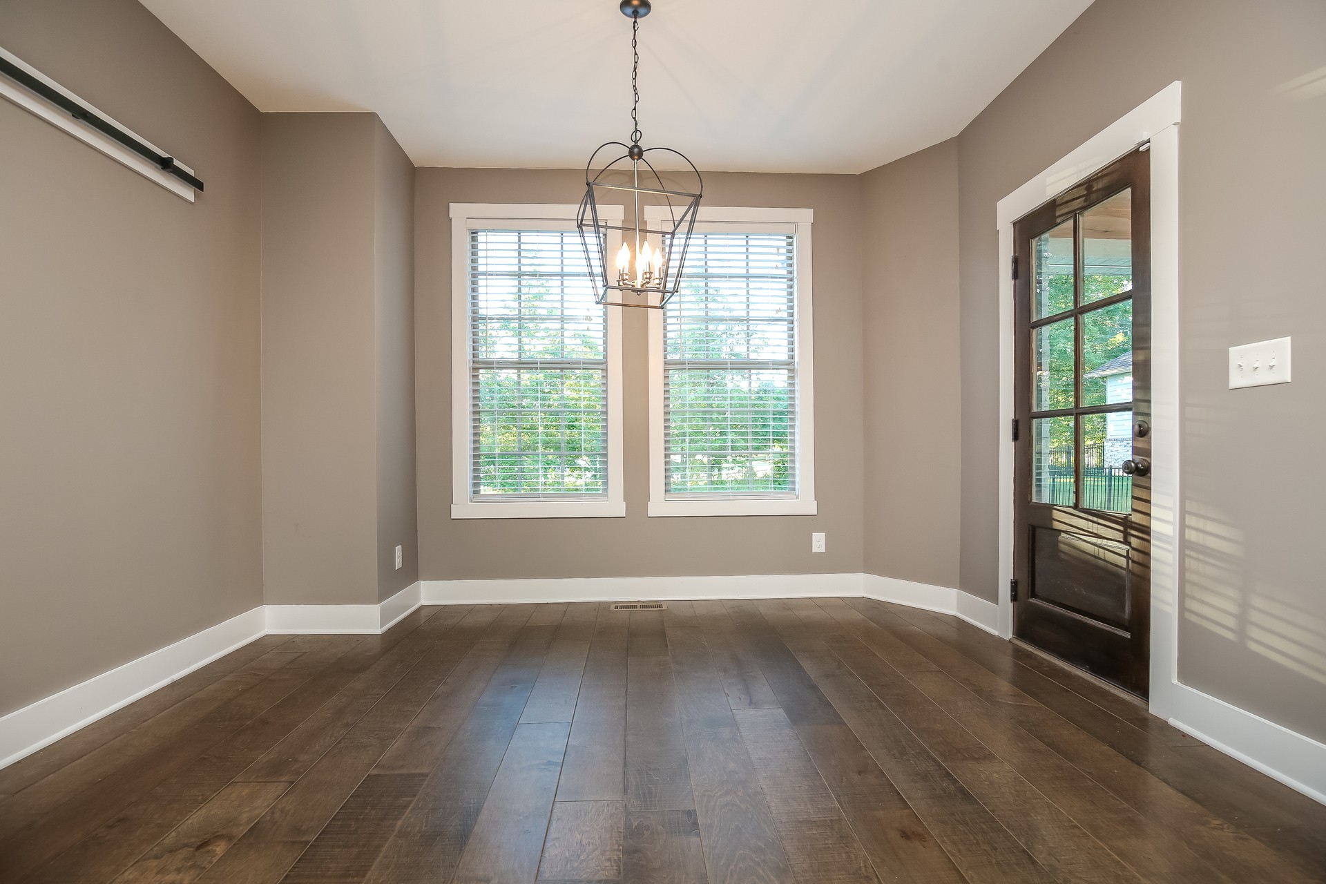 259 Harrowgate Drive Clarksville, TN 37043 - Photo 13 of 27 an empty room with wooden floor and windows