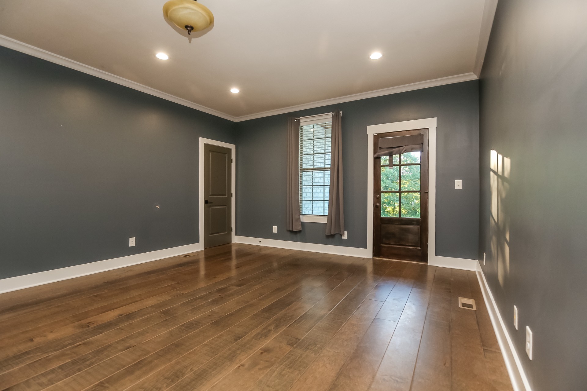 259 Harrowgate Drive Clarksville, TN 37043 - Photo 17 of 27 an empty room with wooden floor and windows