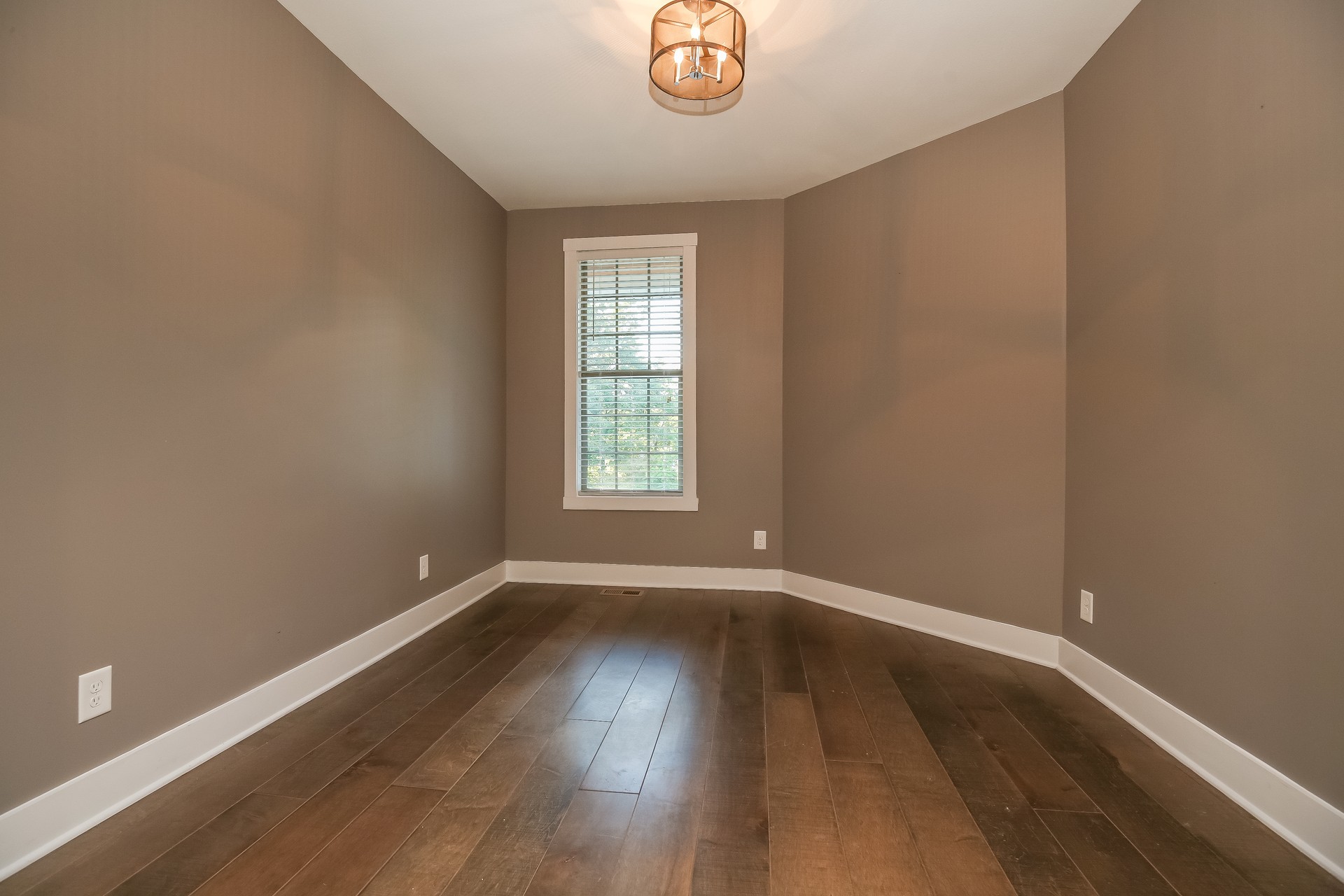 259 Harrowgate Drive Clarksville, TN 37043 - Photo 20 of 27 an empty room with wooden floor and windows