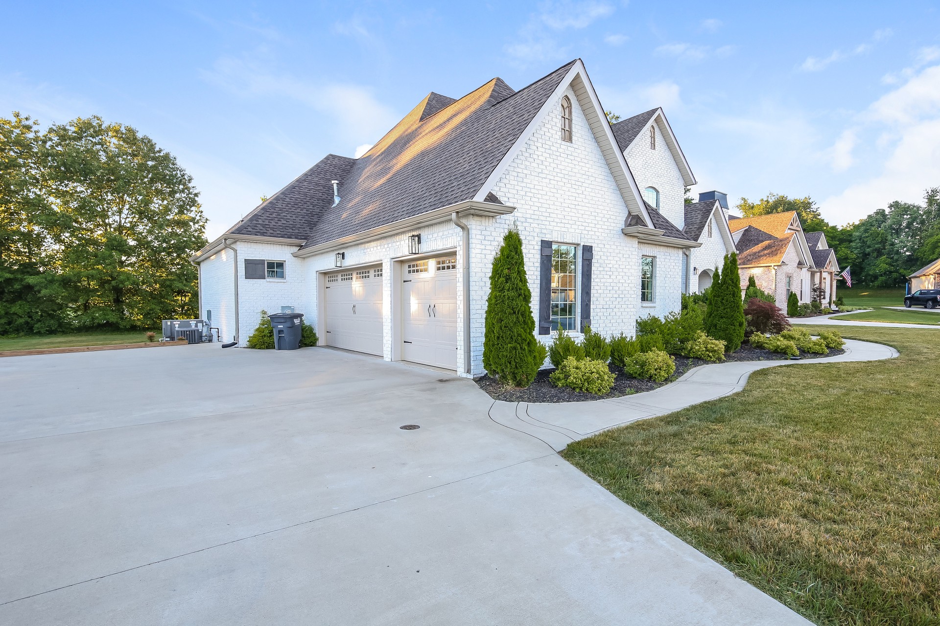 259 Harrowgate Drive Clarksville, TN 37043 - Photo 8 of 27 a view of a white house next to a yard and a large tree