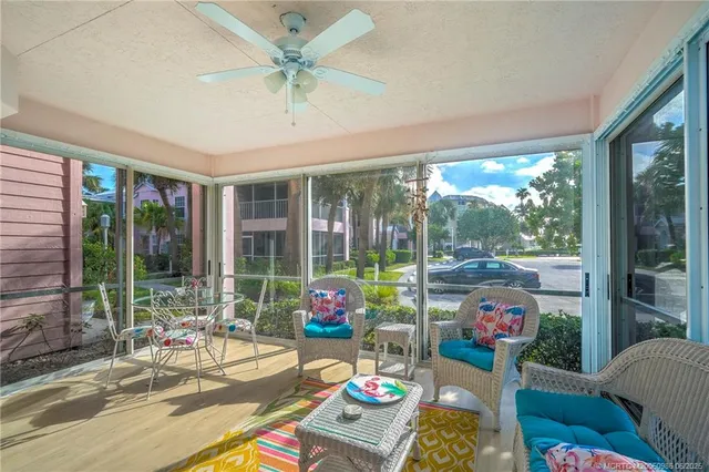 a living room filled with furniture and a large window