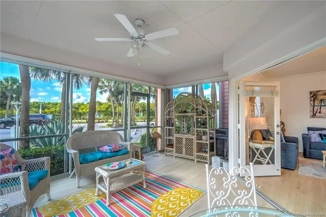 a living room filled with furniture and a large window