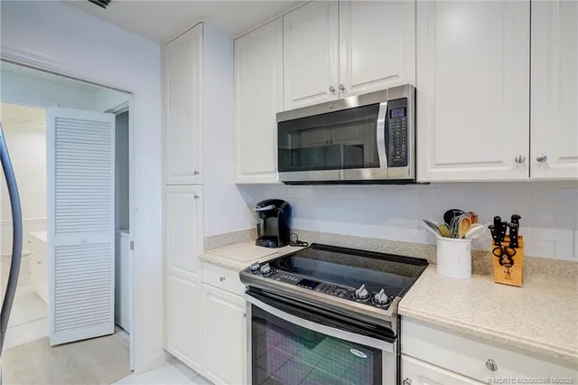 a kitchen with stainless steel appliances a stove a microwave and cabinets