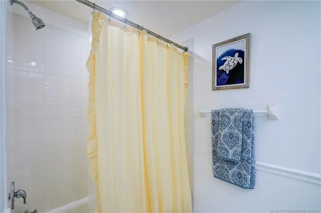 a bathroom with a shower curtain and a curtain