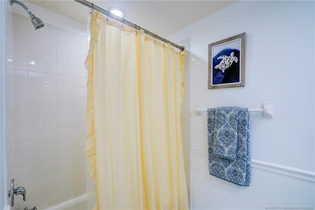 411 Northeast Plantation Road, Unit 511 Stuart, FL 34996 - Photo 22 of 45 a bathroom with a shower curtain and a curtain