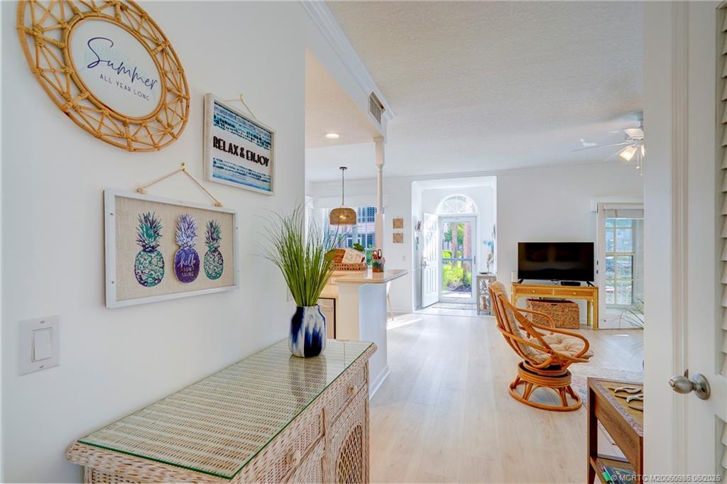 411 Northeast Plantation Road, Unit 511 Stuart, FL 34996 - Photo 28 of 45 a living room with furniture and a flat screen tv