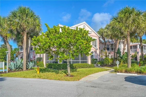 a view of a house with palm trees