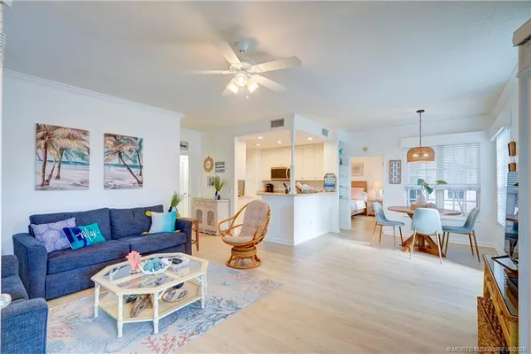 a living room with furniture and kitchen view