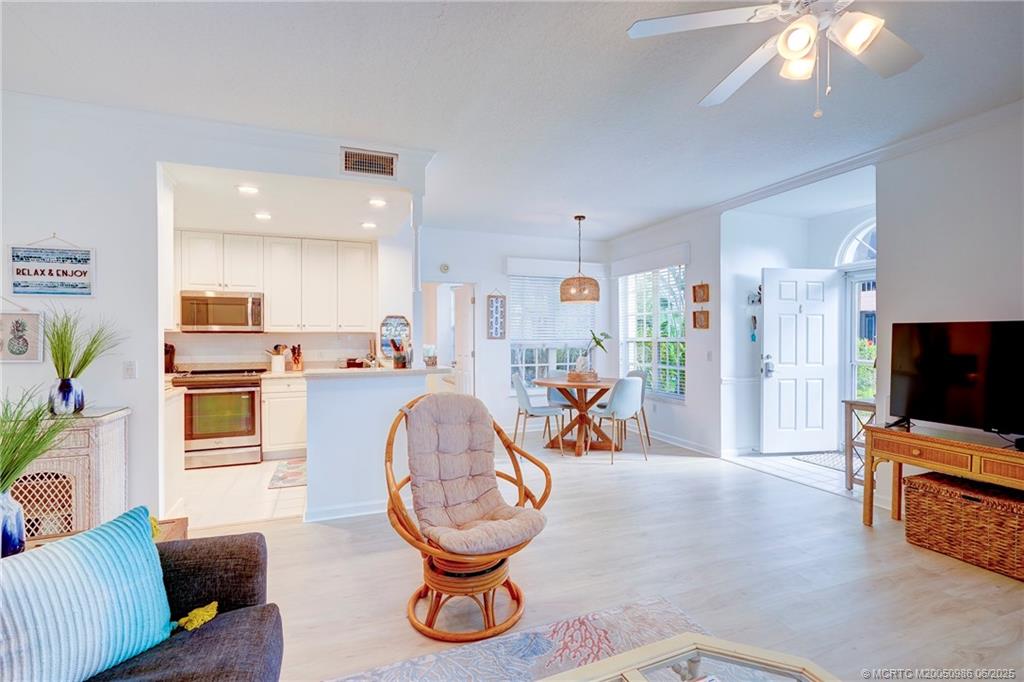 411 Northeast Plantation Road, Unit 511 Stuart, FL 34996 - Photo 10 of 45 a view of a livingroom with furniture and a flat screen tv