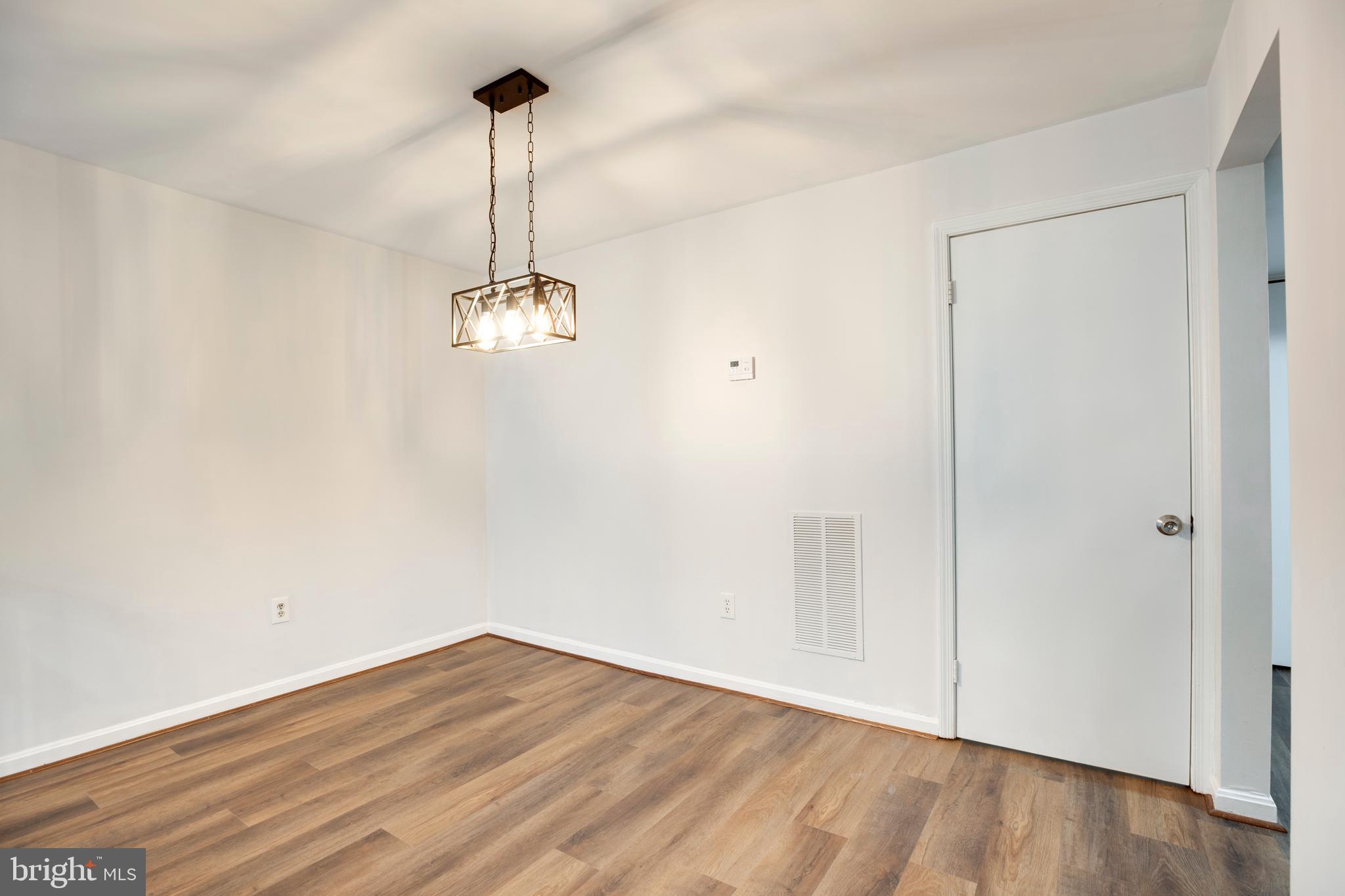 6421 Birch Leaf Court, Unit 36A Burke, VA 22015 - Photo 11 of 26 a view of a room with wooden floor and ceiling fan