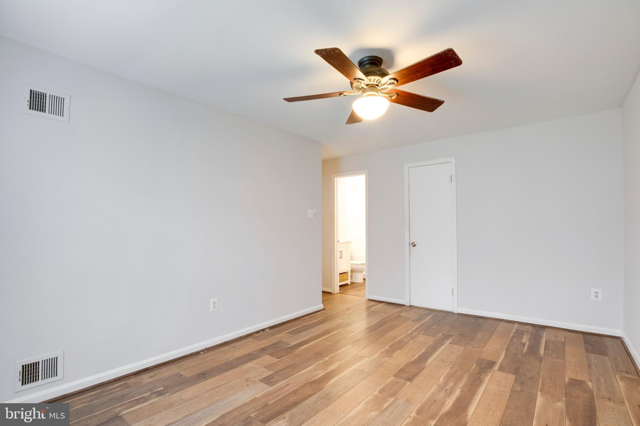 6421 Birch Leaf Court, Unit 36A Burke, VA 22015 - Photo 21 of 26 a view of a livingroom with a ceiling fan and wooden floor