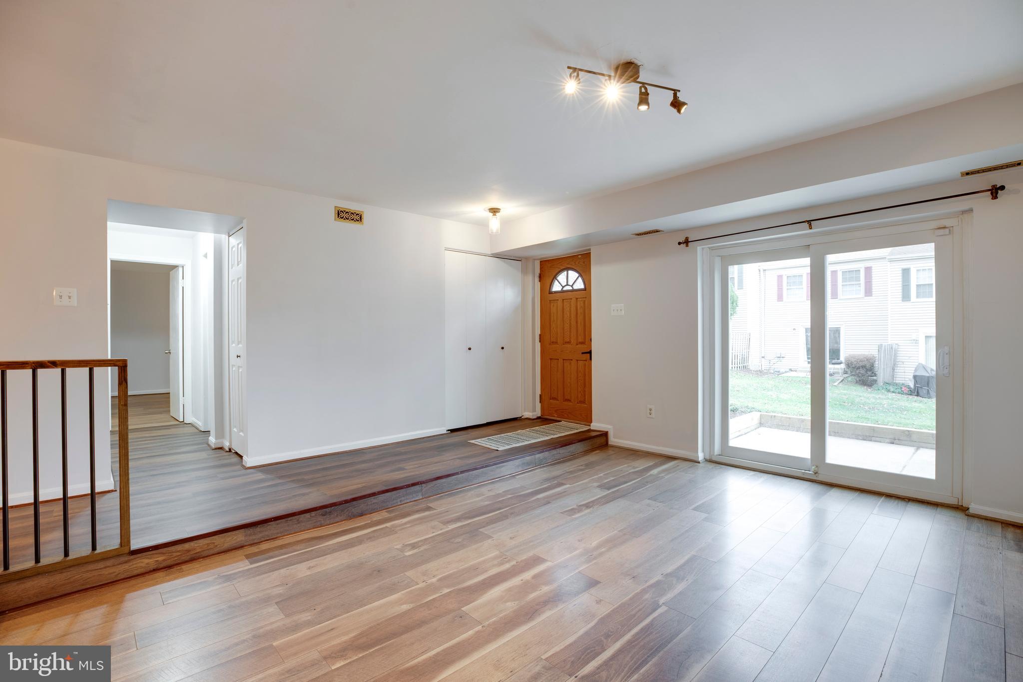 6421 Birch Leaf Court, Unit 36A Burke, VA 22015 - Photo 24 of 26 a view of an empty room with wooden floor and a window