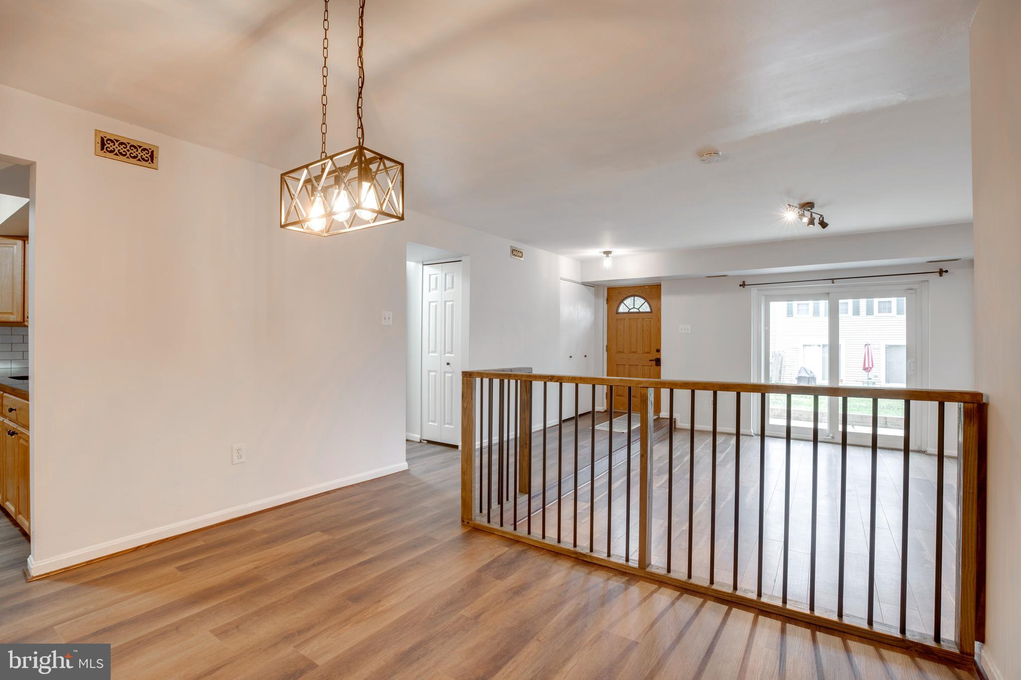 6421 Birch Leaf Court, Unit 36A Burke, VA 22015 - Photo 5 of 26 a view of a hallway with wooden floor and chandelier