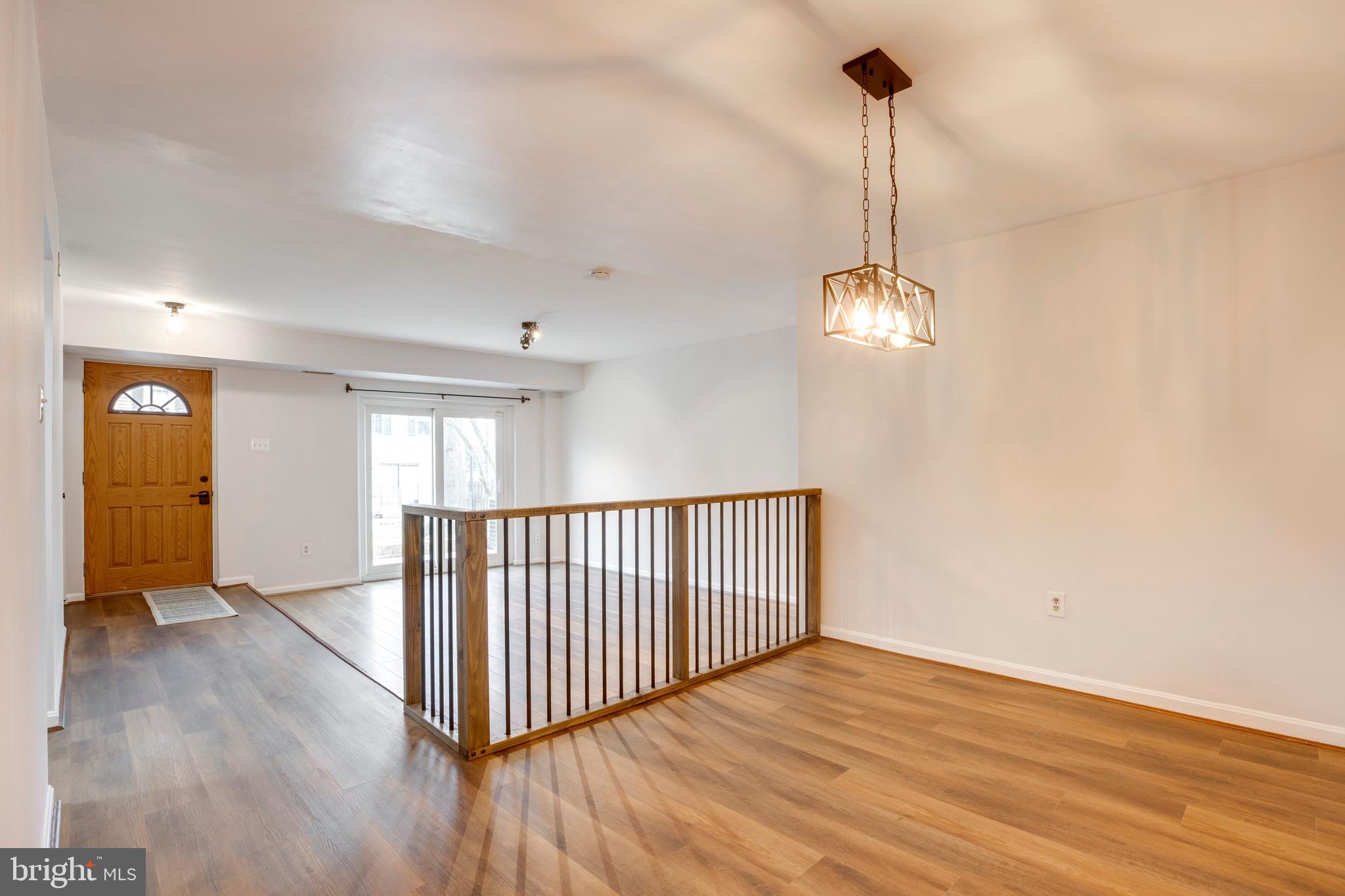 6421 Birch Leaf Court, Unit 36A Burke, VA 22015 - Photo 7 of 26 a view of a room with wooden floor staircase and a chandelier
