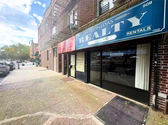a view of street with retail shops