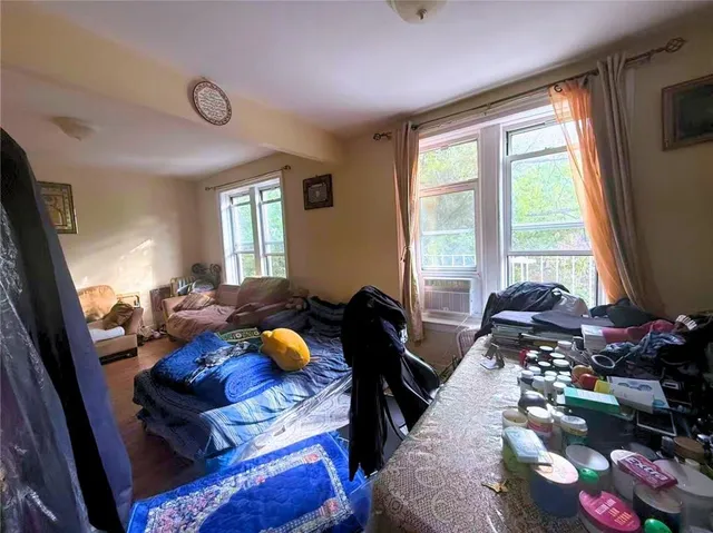 a bedroom with furniture and a large window