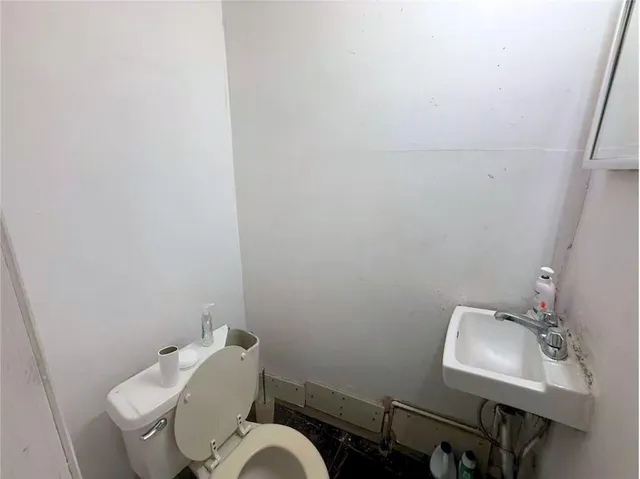 a bathroom with a toilet sink and mirror