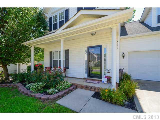 15363 Michael Andrew Road Huntersville, NC 28078 - Photo 2 of 16 a view of a white house with potted plants and a bench