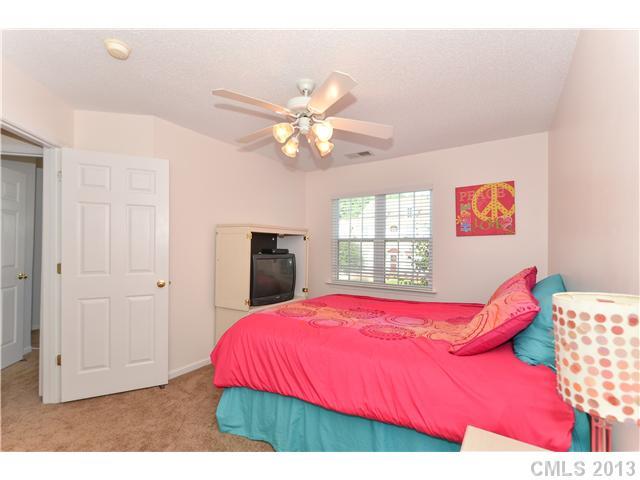 15363 Michael Andrew Road Huntersville, NC 28078 - Photo 13 of 16 a bedroom with a bed and a chandelier