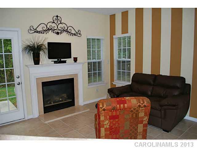 15363 Michael Andrew Road Huntersville, NC 28078 - Photo 7 of 16 a living room with furniture a flat screen tv and a fireplace
