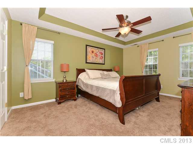 15363 Michael Andrew Road Huntersville, NC 28078 - Photo 9 of 16 a bedroom with a bed and a chandelier