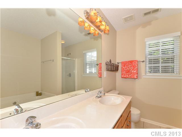 15363 Michael Andrew Road Huntersville, NC 28078 - Photo 10 of 16 a bathroom with a sink a vanity and a mirror